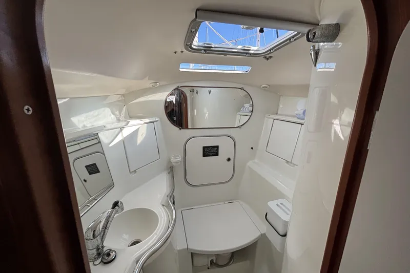 Slide: The Image of Interior of 1997 Beneteau Oceanis 400 yacht bathroom with sink, mirror, and storage. - 76