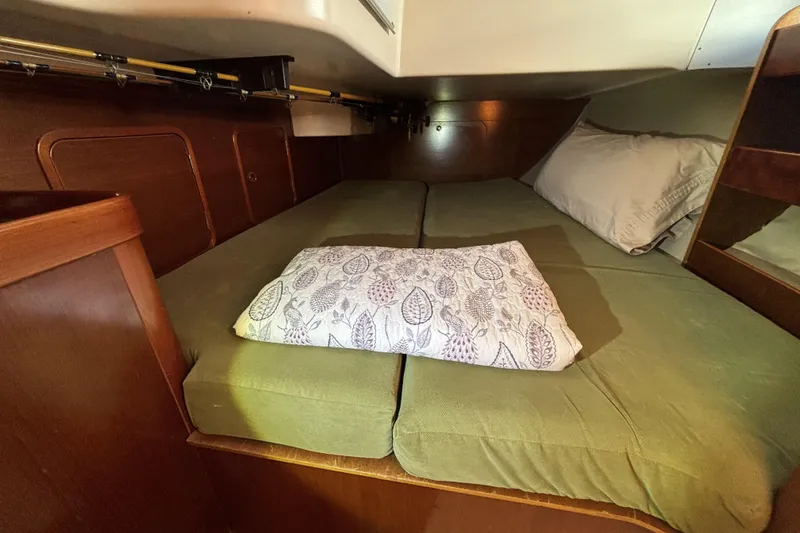Slide: The Image of Cozy cabin interior of 1997 Beneteau Oceanis 400 sailboat with green bedding. - 80