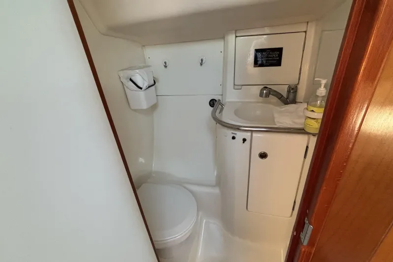 Slide: The Image of Bathroom interior of 1997 Beneteau Oceanis 400 yacht, featuring compact sink and toilet. - 82