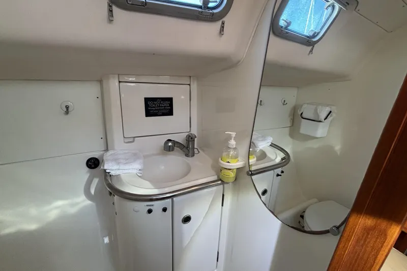 Slide: The Image of Bathroom interior of 1997 Beneteau Oceanis 400 yacht, featuring sink and mirror. - 83