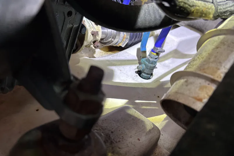 Slide: The Image of Engine compartment of a 1997 Beneteau Oceanis 400 sailboat, showing hoses and fittings. - 89