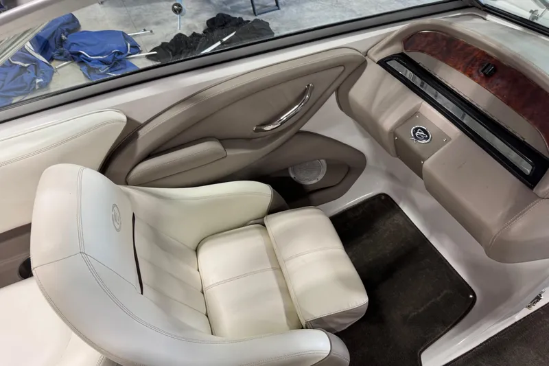 Slide: The Image of 2007 Cobalt 232 boat interior with white leather seating and wood accents. - 10