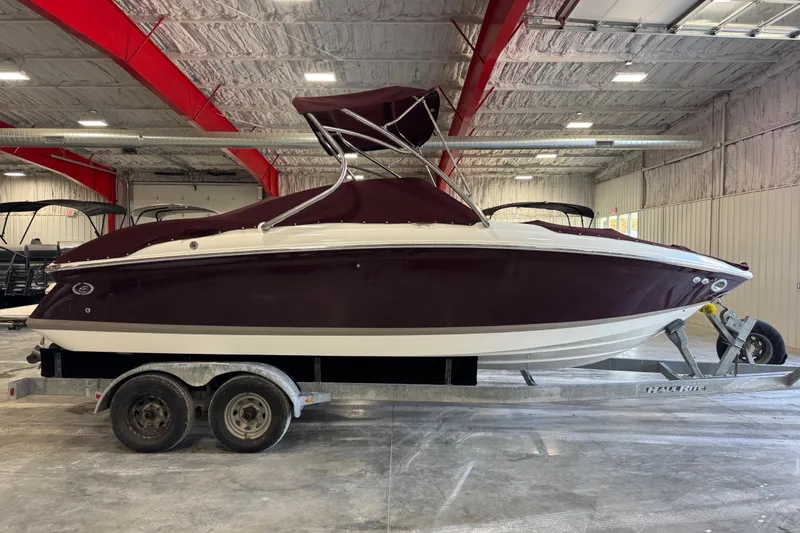 Slide: The Image of 2007 Cobalt 232 boat on trailer in indoor storage facility. - 12