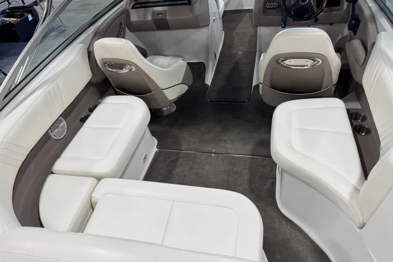 Slide: The Image of Interior of a 2007 Cobalt 232 boat with white seating and gray carpet. - 6