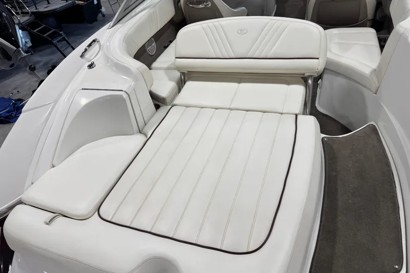 Slide: The Image of 2007 Cobalt 232 boat interior with white cushioned seating and sleek design. - 8