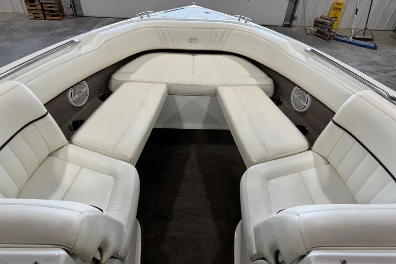 Slide: The Image of 2007 Cobalt 232 boat interior with white leather seating and built-in speakers. - 9