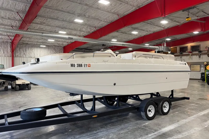 The Image of 2000 Harris-Kayot 24 Legend boat on trailer in indoor storage facility. - 1