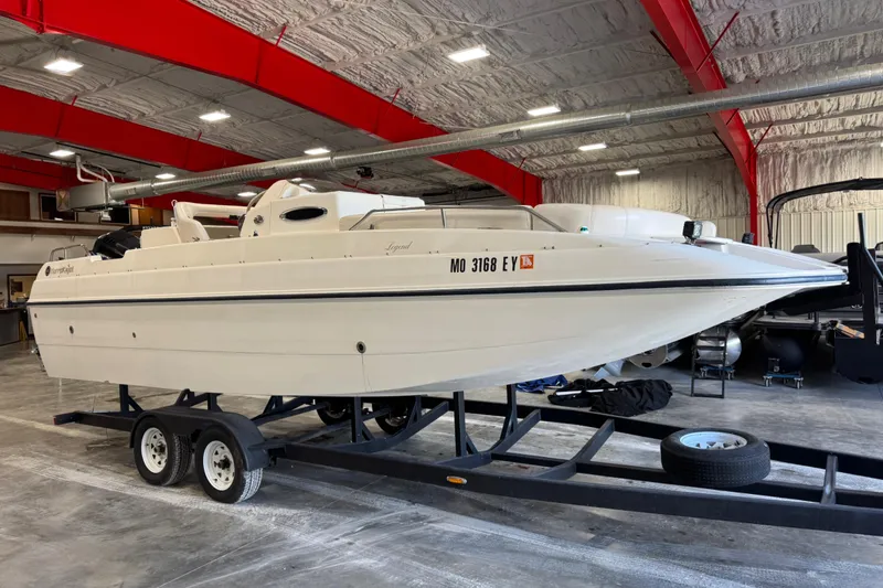 Slide: The Image of 2000 Harris-Kayot 24 Legend boat on trailer in indoor storage facility. - 3