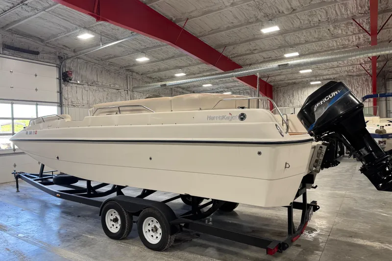 Slide: The Image of 2000 Harris-Kayot 24 Legend boat on trailer in indoor storage facility. - 4