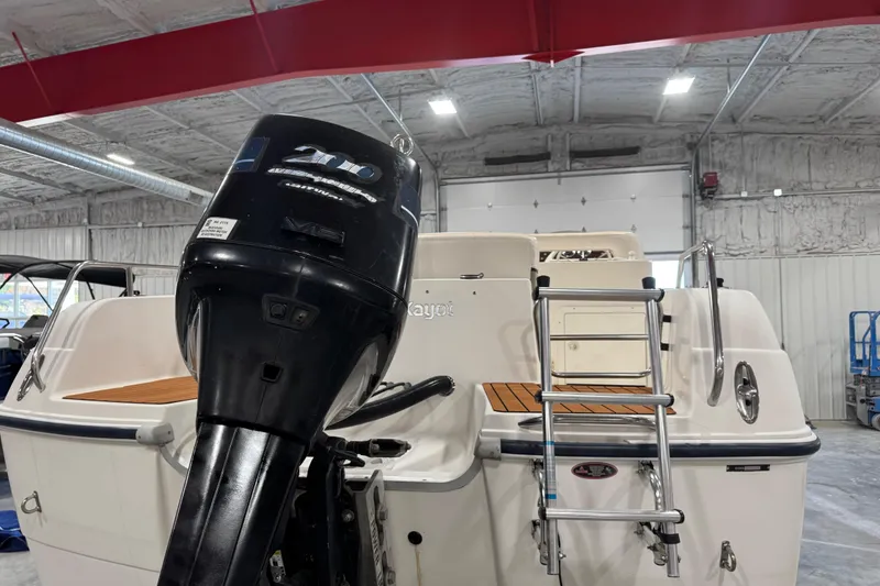 Slide: The Image of 2000 Harris-Kayot 24 Legend boat with outboard motor in a garage setting. - 6