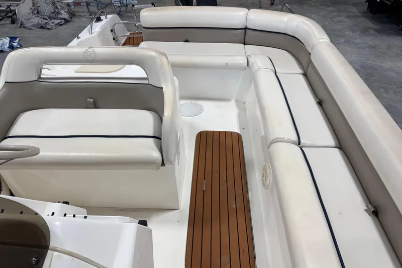 Slide: The Image of 2000 Harris-Kayot 24 Legend boat interior with white seating and wooden flooring. - 7