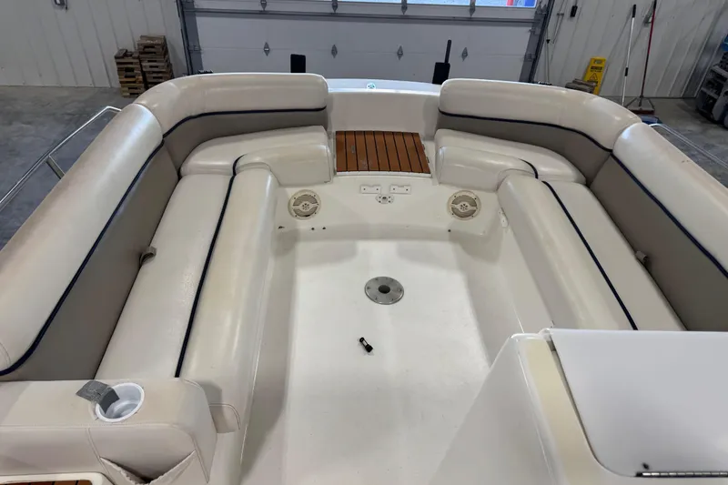 Slide: The Image of 2000 Harris-Kayot 24 Legend boat interior with white cushioned seating and wooden accents. - 9
