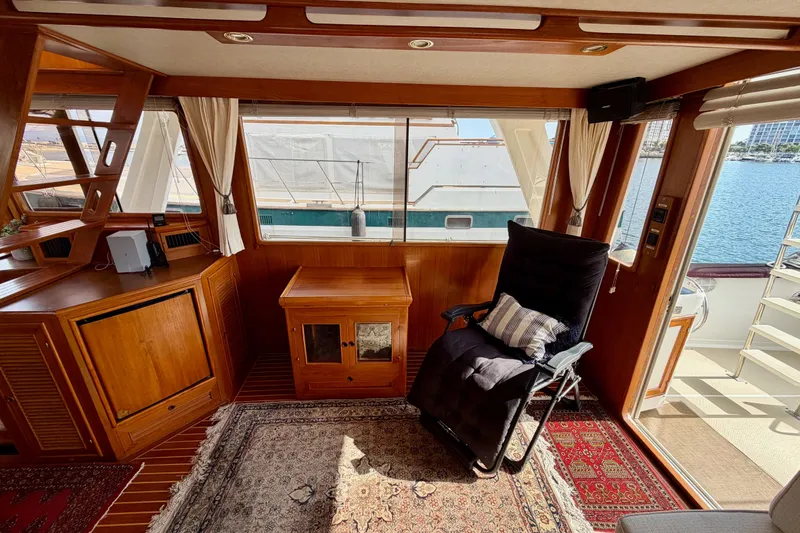 Slide: The Image of Interior of 1988 Offshore Yachts 48 Sedan with wooden furnishings and a reclining chair. - 25