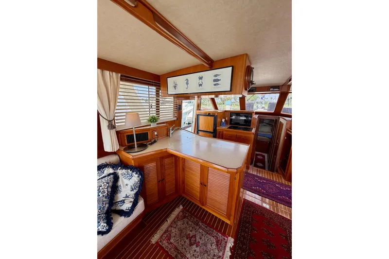 Slide: The Image of Interior of 1988 Offshore Yachts 48 Sedan, featuring wood cabinetry and nautical decor. - 26