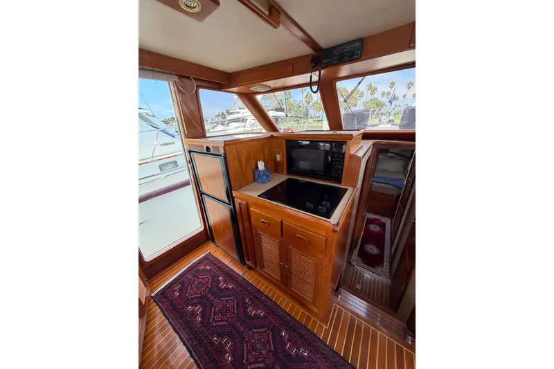 Slide: The Image of Interior of 1988 Offshore Yachts 48 Sedan with wood cabinetry and modern appliances. - 30