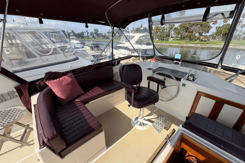 Slide: The Image of Interior view of 1988 Offshore Yachts 48 Sedan, featuring helm and seating area. - 40
