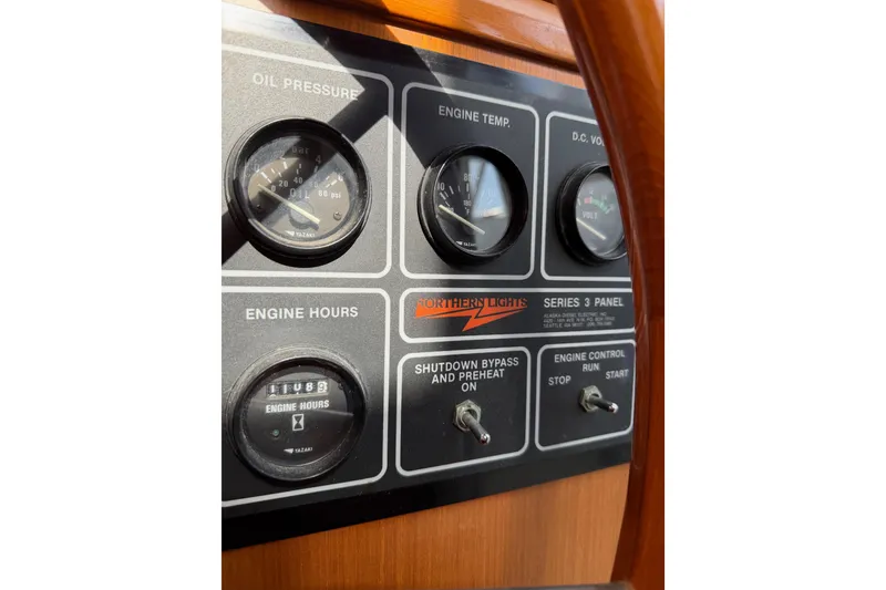Slide: The Image of Control panel of a 1988 Offshore Yachts 48 Sedan, featuring gauges and switches. - 48