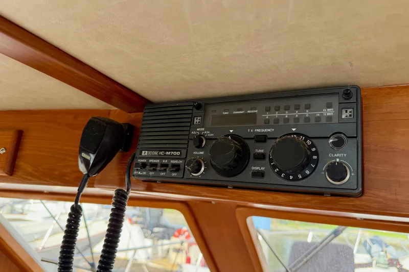 Slide: The Image of Radio equipment on 1988 Offshore Yachts 48 Sedan, featuring Icom IC-M700 marine radio. - 52