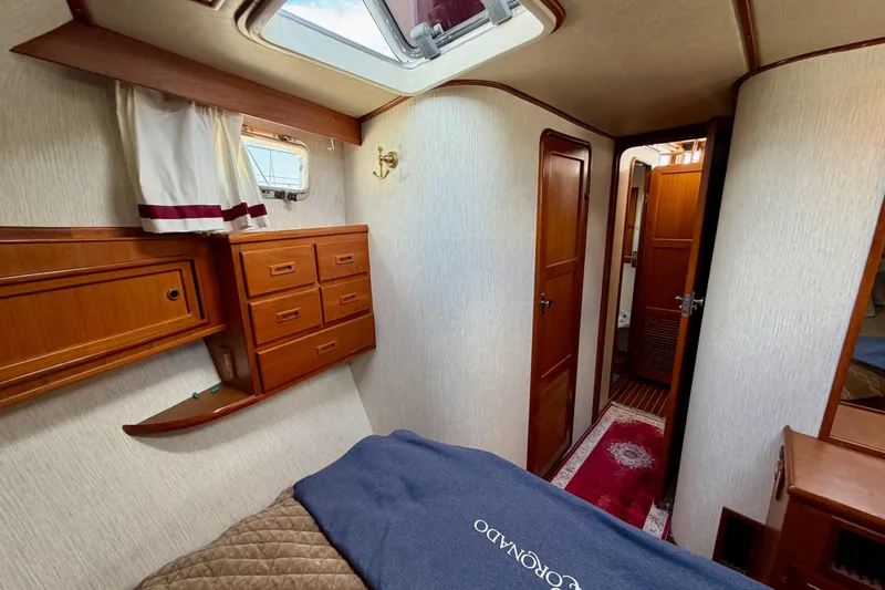 Slide: The Image of Interior of 1988 Offshore Yachts 48 Sedan, featuring wood cabinetry and cozy sleeping quarters. - 68