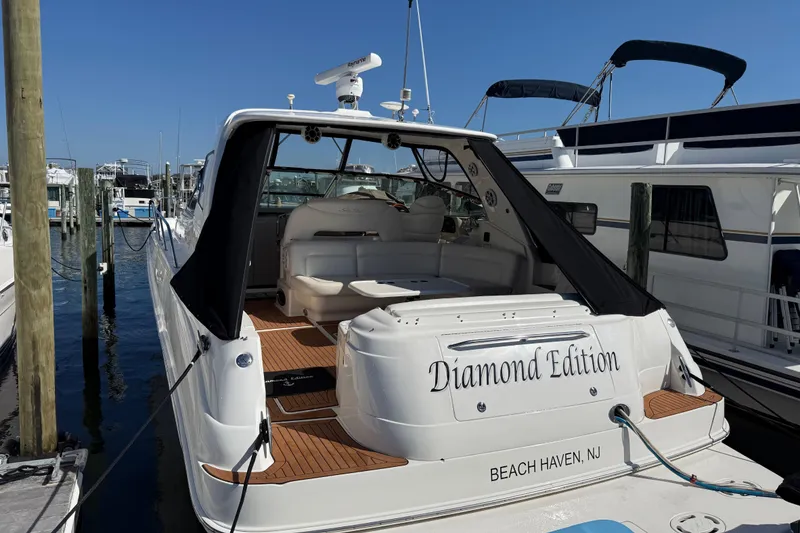 Slide: The Image of Luxurious seating area on a 2003 Sea Ray 460 Sundancer yacht with white cushions. - 13