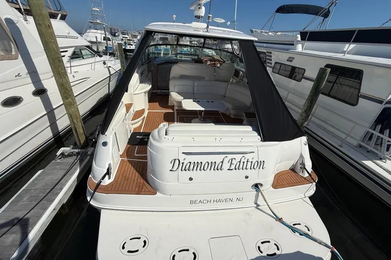 Slide: The Image of Luxurious 2003 Sea Ray 460 Sundancer yacht interior with white leather seating and wooden flooring. - 14