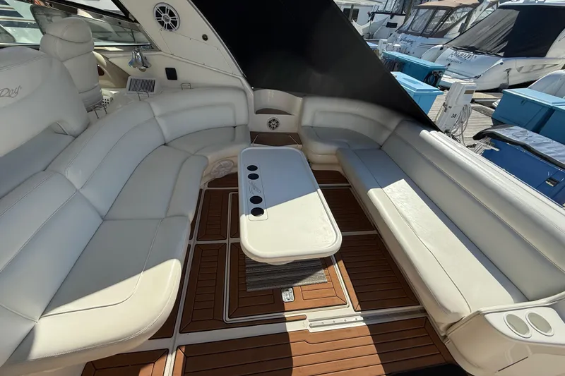 Slide: The Image of Interior of 2003 Sea Ray 460 Sundancer yacht with white seating and wooden flooring. - 16