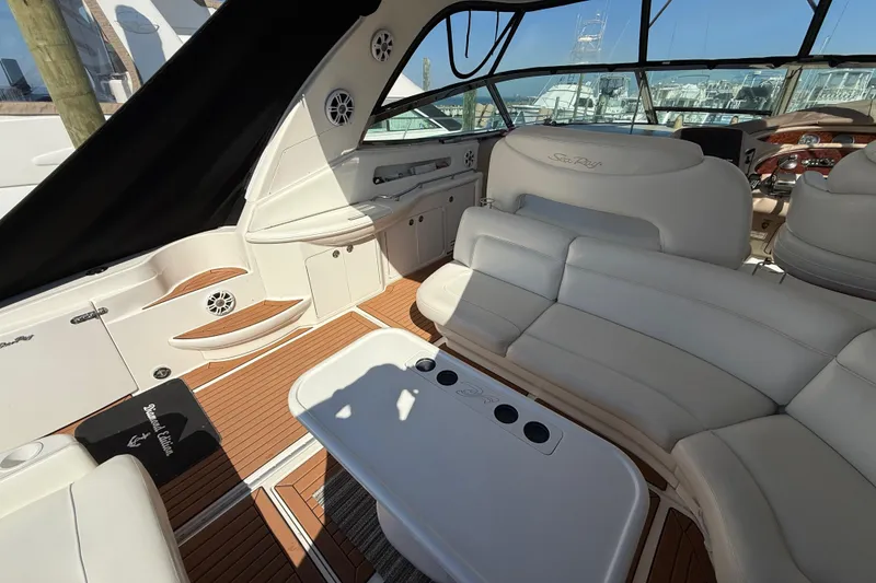 Slide: The Image of Captain's chair on 2003 Sea Ray 460 Sundancer yacht, featuring luxurious white leather upholstery. - 17