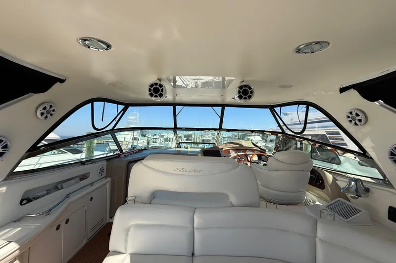 Slide: The Image of Captain's chair on 2003 Sea Ray 460 Sundancer yacht, featuring luxurious white leather upholstery. - 18