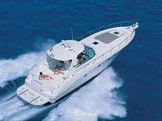 Slide: The Image of 2003 Sea Ray 460 Sundancer yacht docked at marina under clear blue sky. - 2