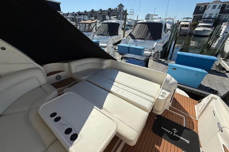 Slide: The Image of 2003 Sea Ray 460 Sundancer helm with wood accents and modern navigation equipment. - 20