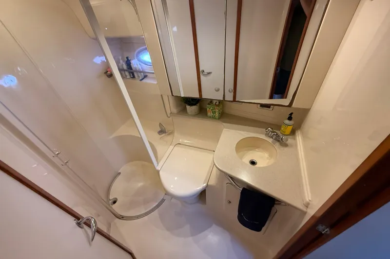 Slide: The Image of Interior of 2003 Sea Ray 460 Sundancer yacht with wooden cabinetry and plush seating. - 41