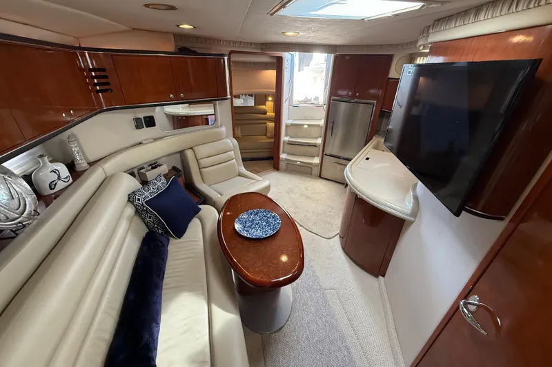 Slide: The Image of 2003 Sea Ray 460 Sundancer yacht docked among other boats at a marina. - 44