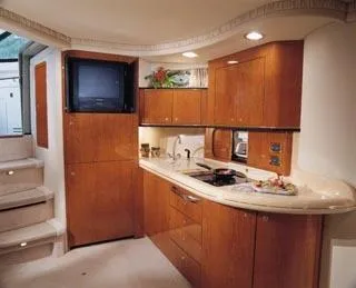 Slide: The Image of 2003 Sea Ray 460 Sundancer yacht interior with white seating and wooden flooring. - 5