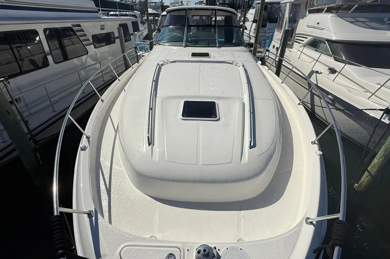 Slide: The Image of Control panel of a 2003 Sea Ray 460 Sundancer yacht with various switches and systems monitor. - 54