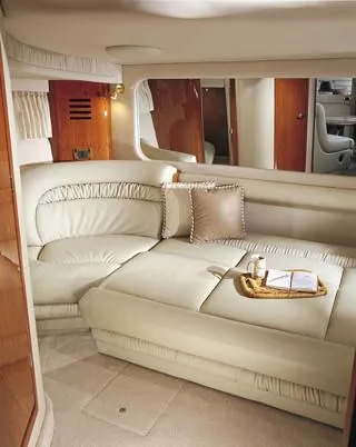 Slide: The Image of Luxurious 2003 Sea Ray 460 Sundancer yacht interior with white seating and wooden flooring. - 6