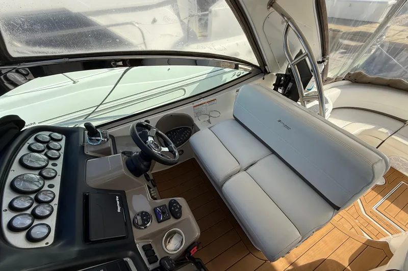 Slide: The Image of 2008 Cruisers Yachts 420 Express helm with white seating and control panel. - 20