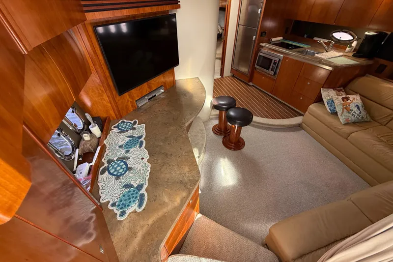 Slide: The Image of 2008 Cruisers Yachts 420 Express interior with kitchen, seating, and TV area. - 26