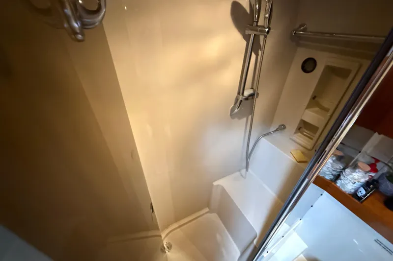 Slide: The Image of Shower area in 2008 Cruisers Yachts 420 Express, featuring modern fixtures and storage shelves. - 31