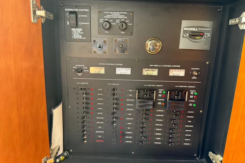 Slide: The Image of Electrical control panel of 2008 Cruisers Yachts 420 Express, featuring generator and circuit controls. - 36