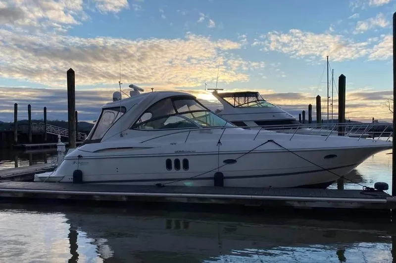 The Image of 2008 Cruisers Yachts 420 Express docked at sunset with scenic sky. - 0
