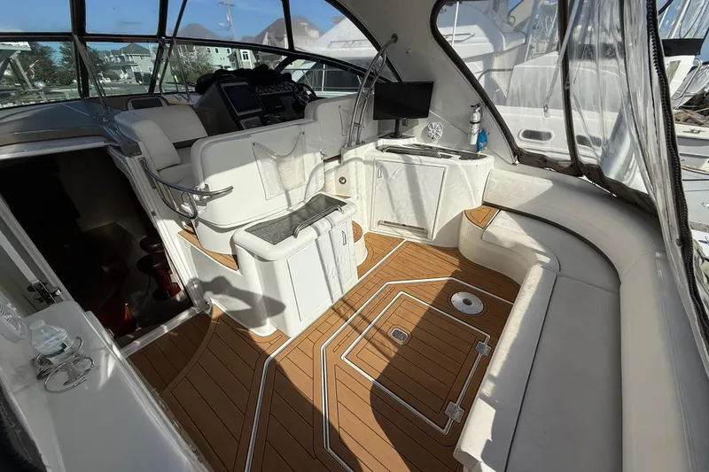 Slide: The Image of 2008 Cruisers Yachts 420 Express interior with white seating and wood flooring. - 16