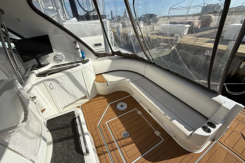 Slide: The Image of 2008 Cruisers Yachts 420 Express interior with seating, TV, and wood flooring. - 17