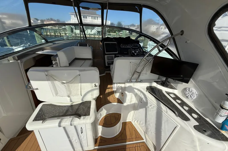 Slide: The Image of 2008 Cruisers Yachts 420 Express cockpit with helm, seating, and modern amenities. - 18