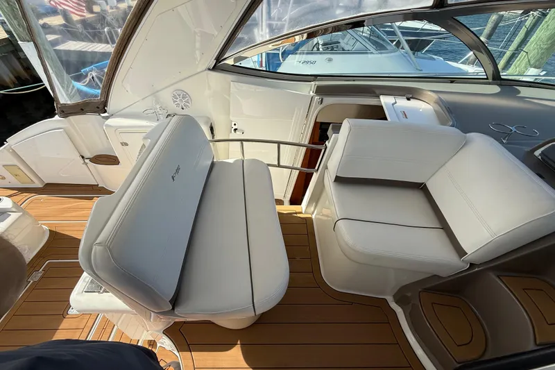Slide: The Image of 2008 Cruisers Yachts 420 Express interior with white seating and wooden flooring. - 19