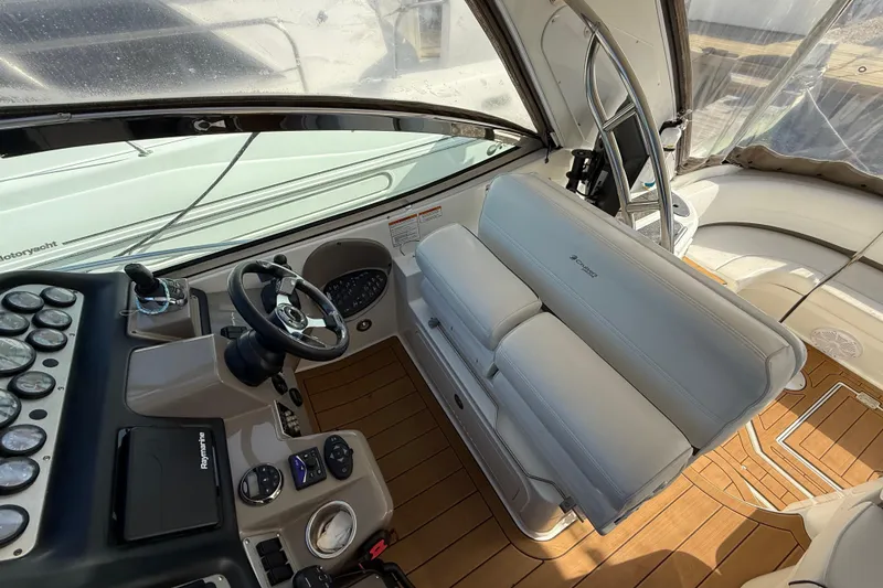 Slide: The Image of 2008 Cruisers Yachts 420 Express helm with steering wheel and control panel. - 21