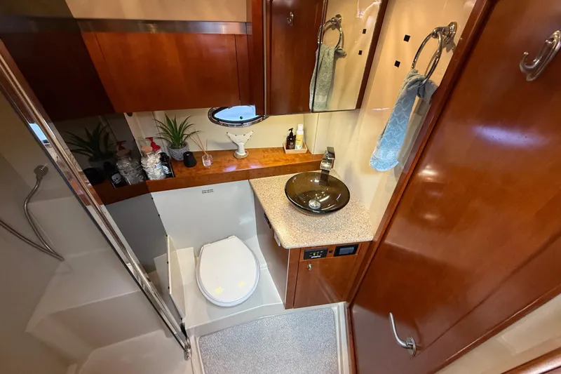Slide: The Image of Luxurious 2008 Cruisers Yachts 420 Express bathroom with modern fixtures and elegant wood finishes. - 30