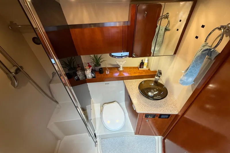 Slide: The Image of Luxurious 2008 Cruisers Yachts 420 Express bathroom with modern fixtures and elegant wood cabinetry. - 32