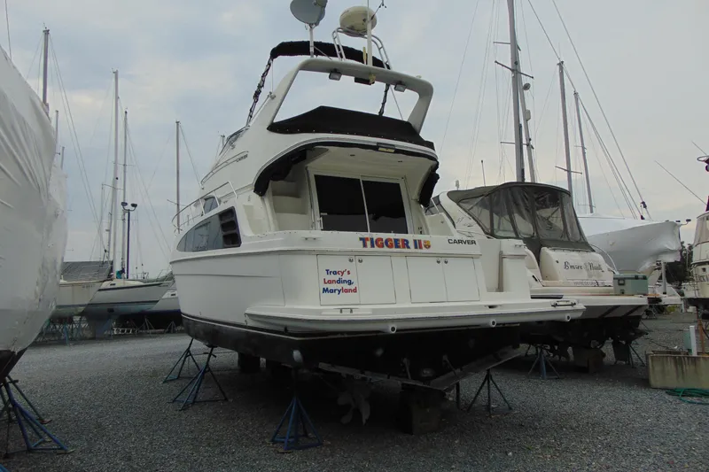 Slide: The Image of 2003 Carver 360 Sport Sedan yacht on stands at a marina, Tracy's Landing, Maryland. - 3