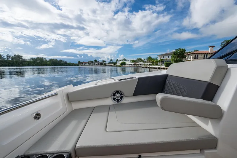 Slide: The Image of 2023 Aquila 32 Power Cat interior with luxurious seating, overlooking serene waterfront homes. - 10