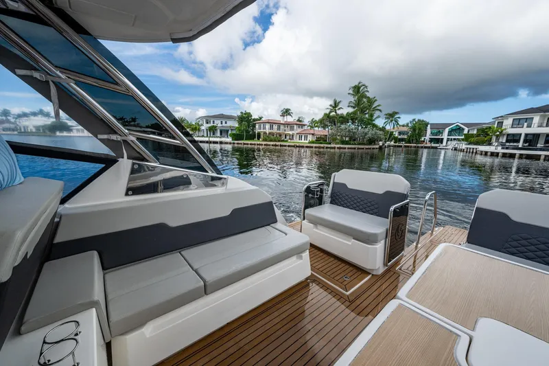 Slide: The Image of Aquila 32 Power Cat 2023 interior with luxurious seating and scenic waterfront view. - 13